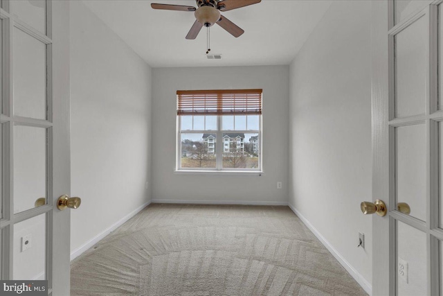 spare room with light carpet and ceiling fan