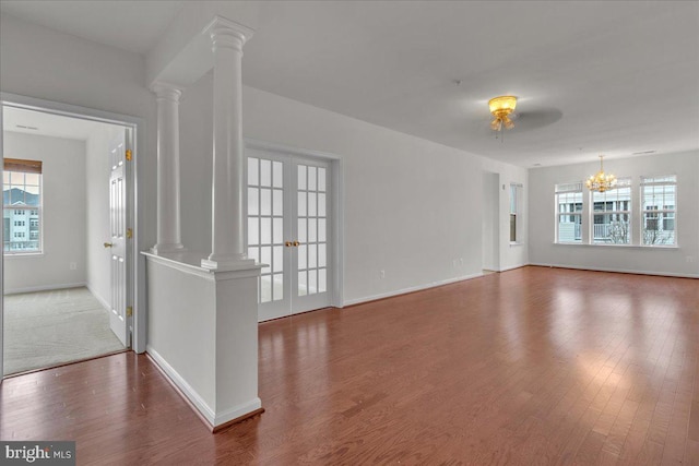 interior space featuring decorative columns, wood-type flooring, and french doors