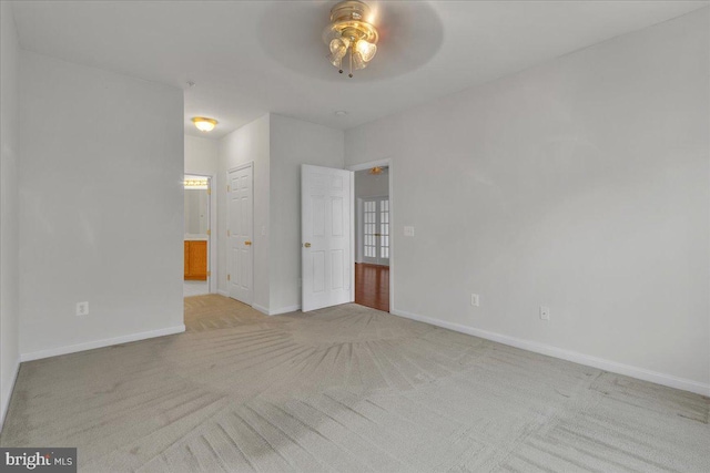 unfurnished bedroom with light carpet and ceiling fan