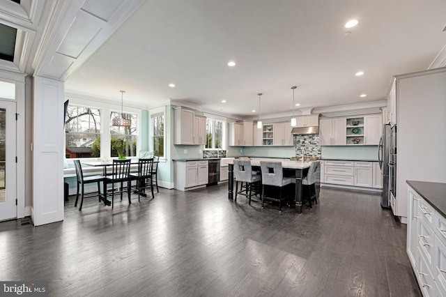 dining room with ornamental molding and dark hardwood / wood-style floors