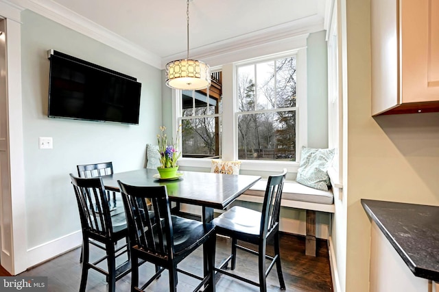 dining room featuring ornamental molding and dark hardwood / wood-style flooring