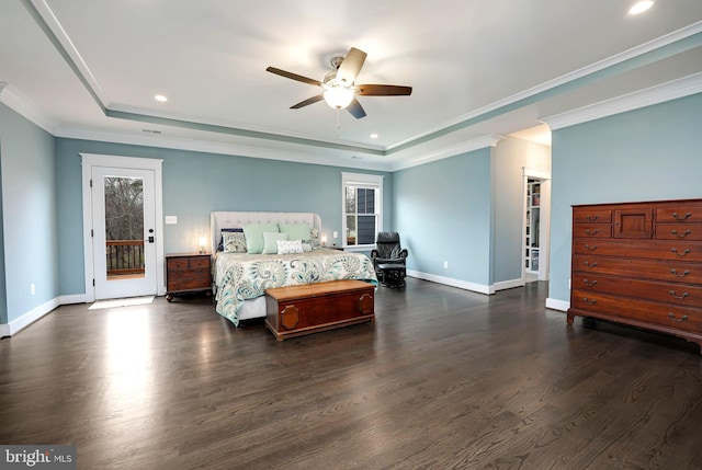 bedroom featuring dark hardwood / wood-style flooring, a tray ceiling, ornamental molding, and ceiling fan