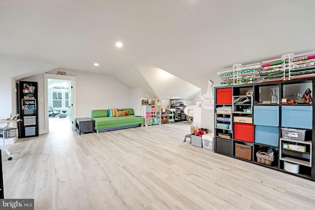 recreation room with vaulted ceiling and light hardwood / wood-style flooring