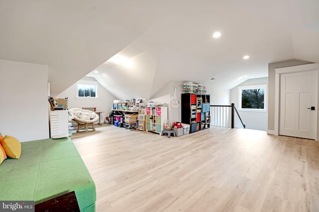 recreation room with hardwood / wood-style flooring and vaulted ceiling