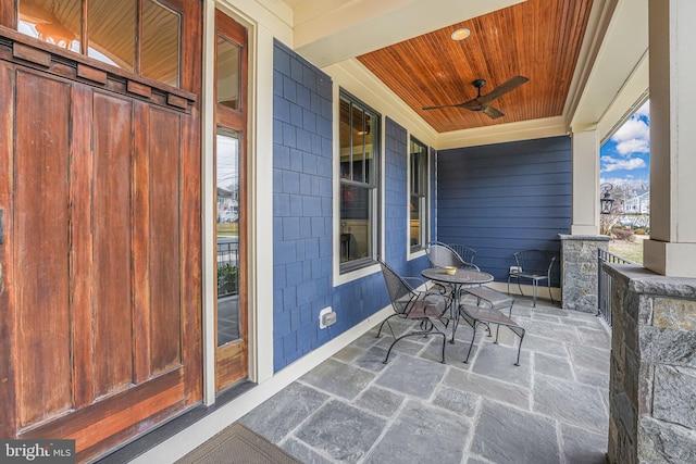 view of patio featuring ceiling fan and a porch