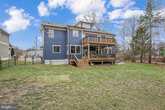 back of property with a lawn and a deck