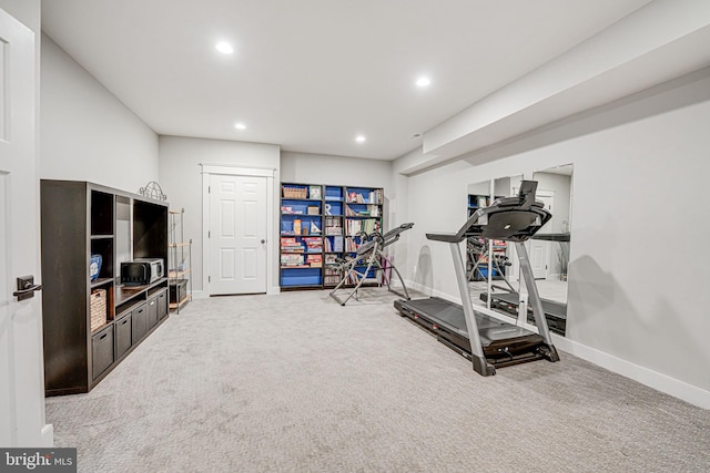 exercise area featuring light colored carpet