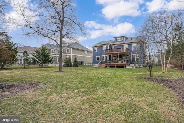 back of property featuring a wooden deck, central air condition unit, and a lawn