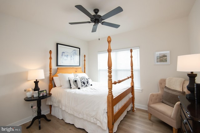 bedroom featuring a ceiling fan, baseboards, and wood finished floors