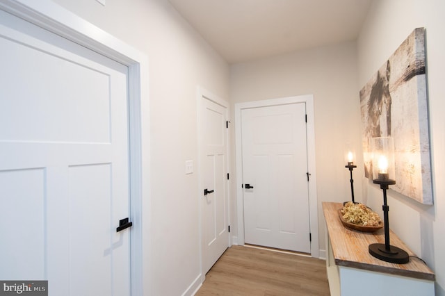 doorway to outside with light wood-style floors