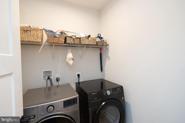 washroom with laundry area and washer and dryer