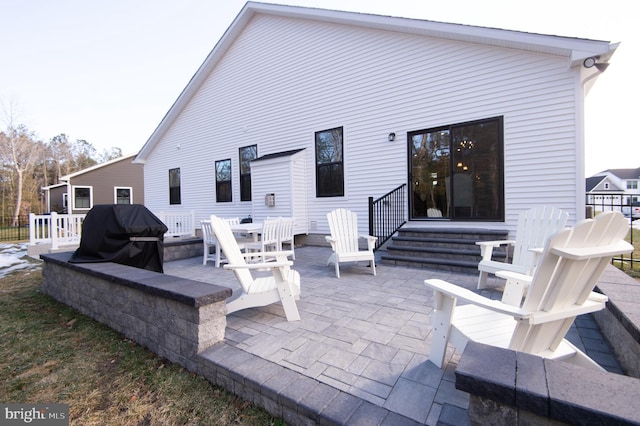 back of house featuring entry steps and a patio area