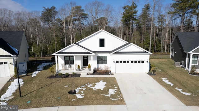 modern farmhouse with a porch, a garage, central AC, driveway, and a front yard