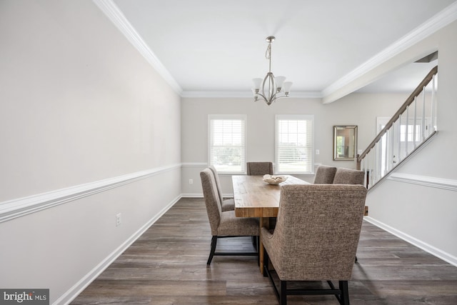 dining space with ornamental molding, dark hardwood / wood-style flooring, and a chandelier