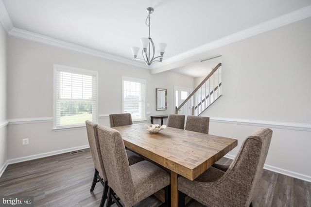 dining space with an inviting chandelier, ornamental molding, and dark hardwood / wood-style flooring