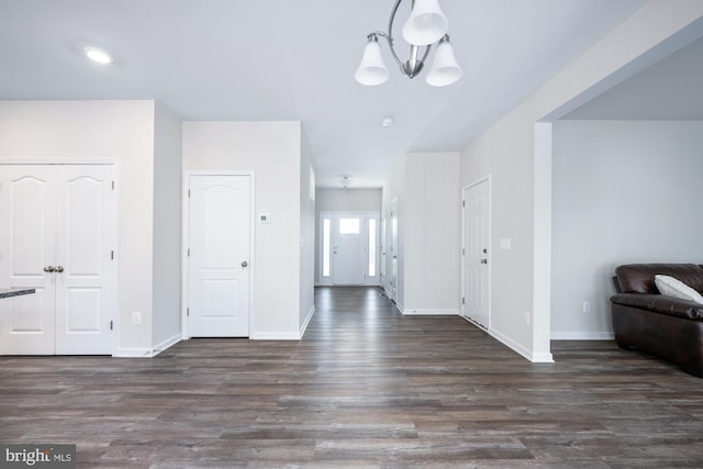 foyer featuring dark hardwood / wood-style flooring and a notable chandelier