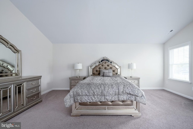 bedroom featuring vaulted ceiling and light colored carpet