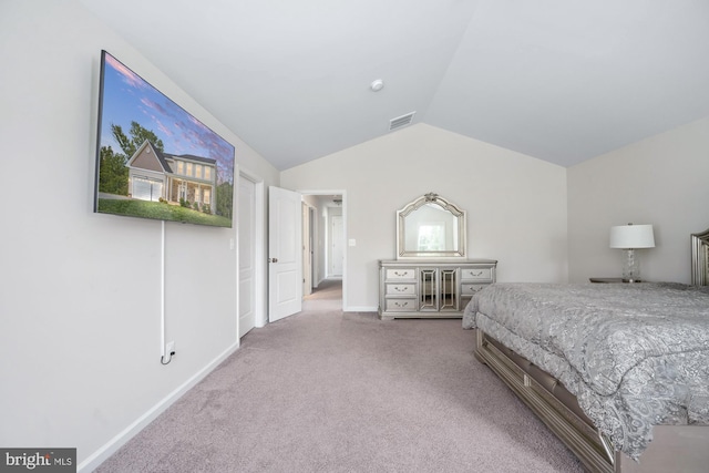 carpeted bedroom with lofted ceiling