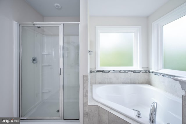 bathroom with shower with separate bathtub