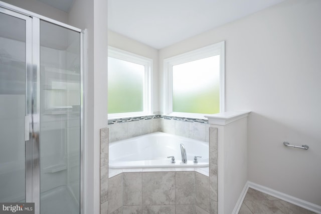 bathroom featuring separate shower and tub