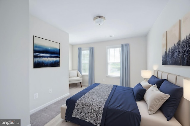 bedroom featuring light colored carpet