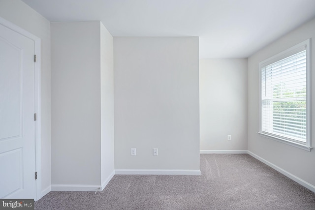 spare room with light colored carpet