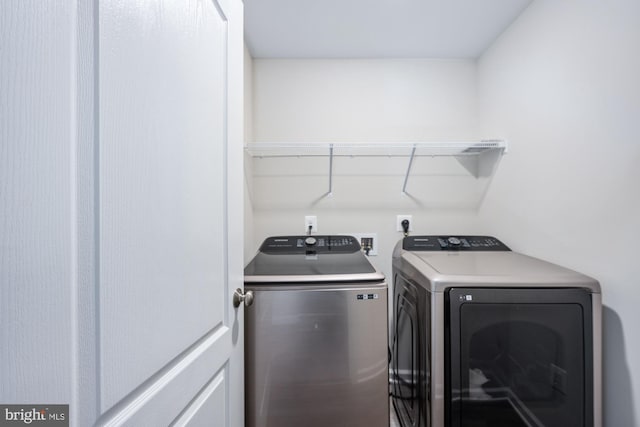 washroom with washing machine and clothes dryer