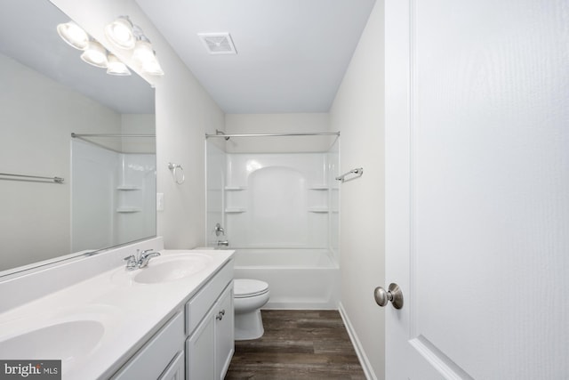 full bathroom featuring vanity, hardwood / wood-style floors, shower / tub combination, and toilet