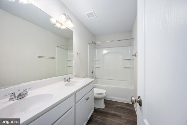 full bathroom featuring wood-type flooring, toilet, shower / bathing tub combination, and vanity