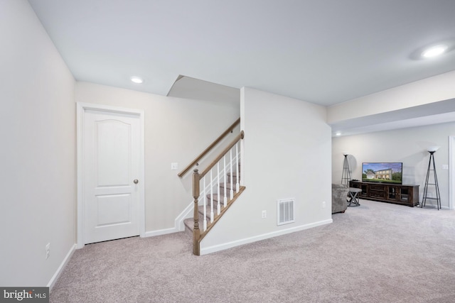 interior space featuring light carpet