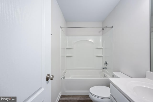 full bathroom with vanity, hardwood / wood-style floors,  shower combination, and toilet