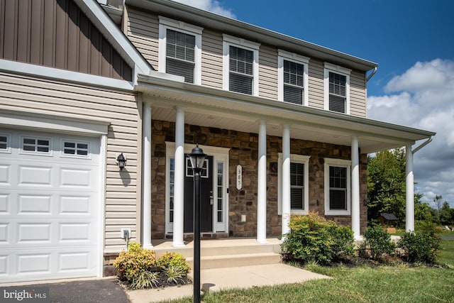 view of exterior entry with a porch