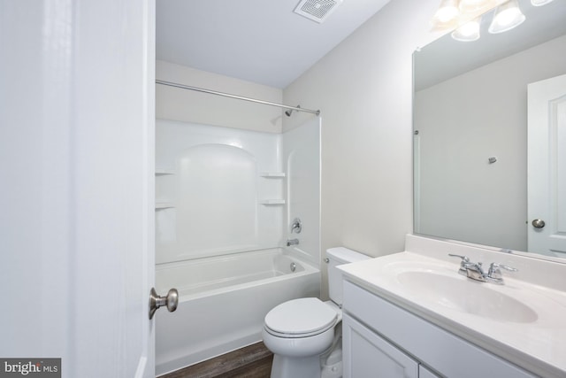 full bathroom featuring washtub / shower combination, wood-type flooring, toilet, and vanity