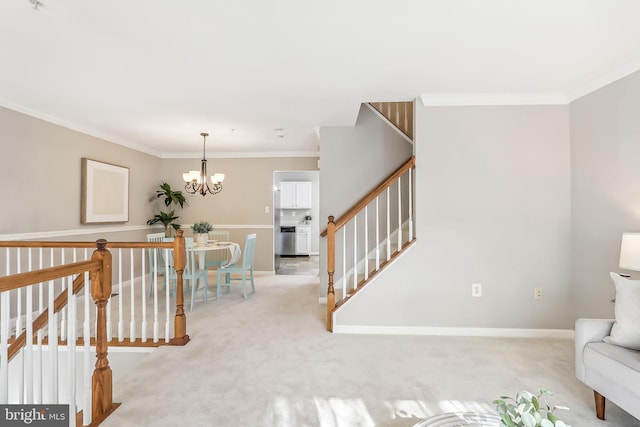 interior space with an inviting chandelier, ornamental molding, and light carpet