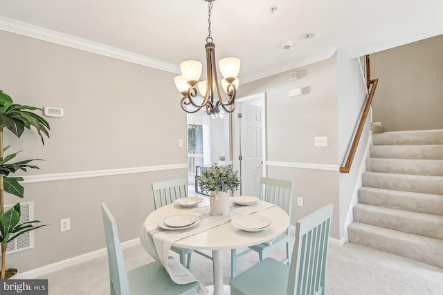 carpeted dining area with crown molding and a chandelier