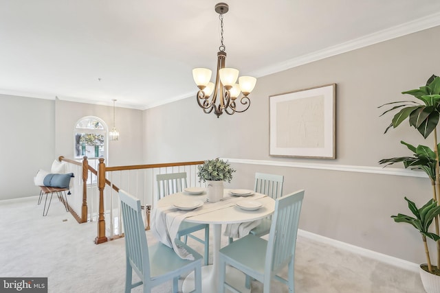 carpeted dining space featuring a notable chandelier and crown molding