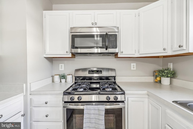 kitchen featuring white cabinets and appliances with stainless steel finishes