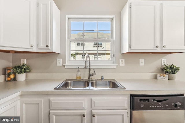 kitchen with sink, white cabinetry, and stainless steel dishwasher