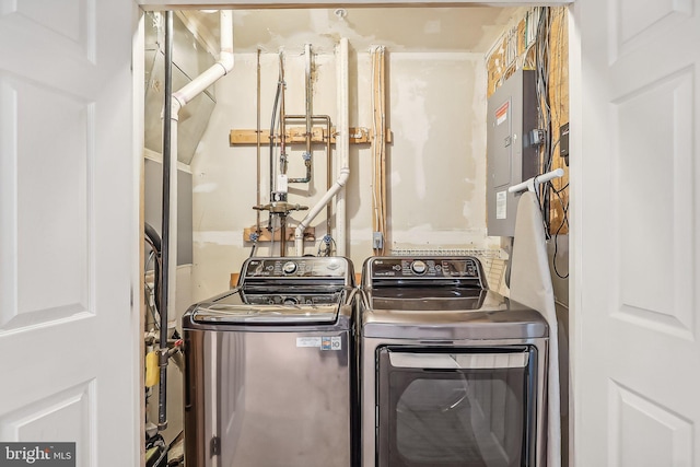 clothes washing area featuring washing machine and clothes dryer and electric panel