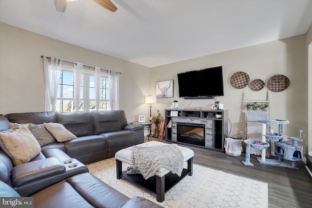 living room featuring hardwood / wood-style floors and ceiling fan