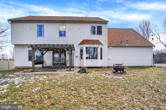 back of property featuring a fire pit, a pergola, a lawn, and a patio