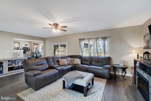 living room featuring ceiling fan and hardwood / wood-style floors