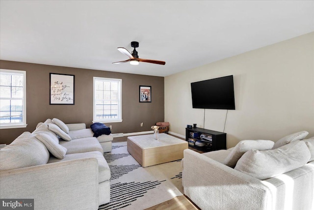 living room featuring light wood-type flooring and ceiling fan