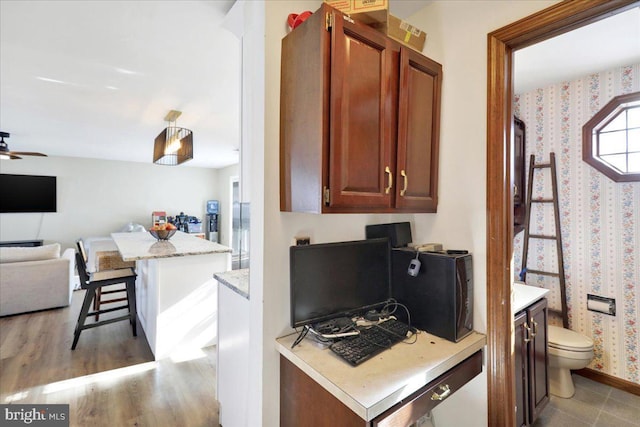 kitchen featuring a kitchen bar and ceiling fan