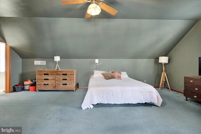 carpeted bedroom with ceiling fan and vaulted ceiling