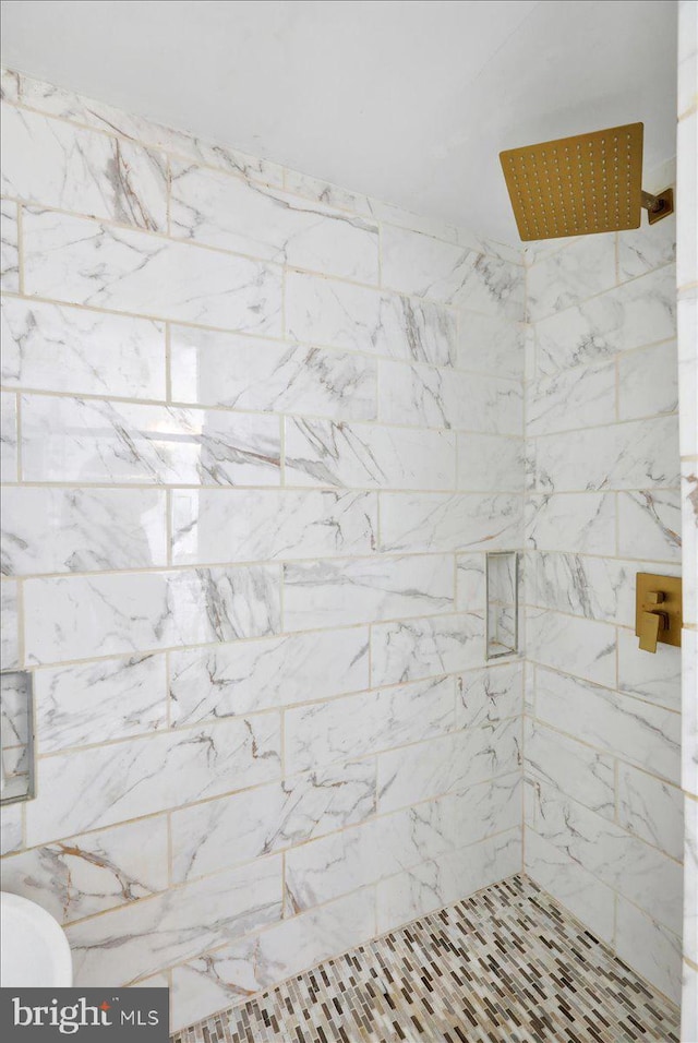 bathroom with tiled shower