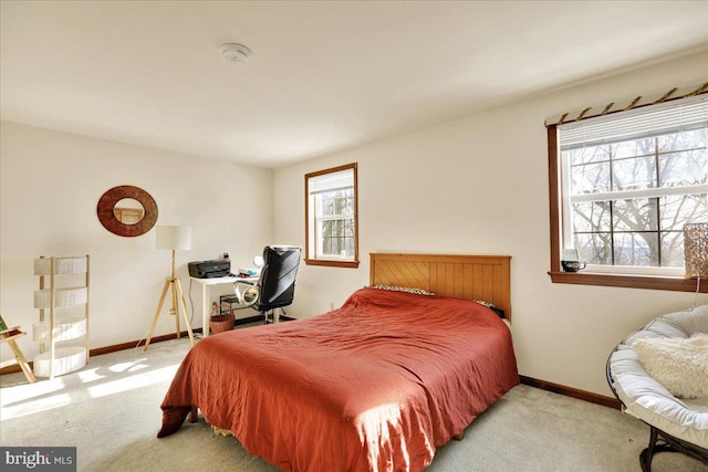 bedroom with multiple windows and light colored carpet