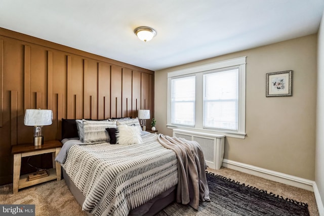 bedroom featuring radiator heating unit and light colored carpet