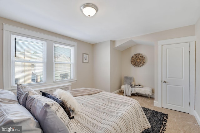 bedroom featuring light carpet