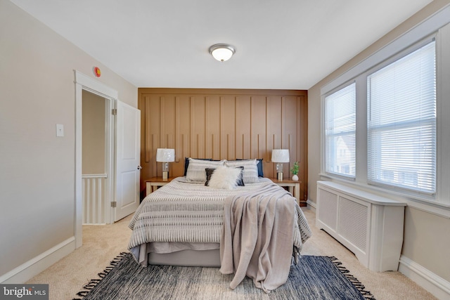 bedroom featuring light colored carpet and radiator